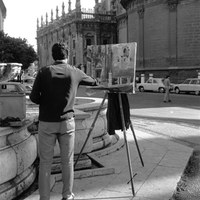 Pintor callejero en la plaza Virgen de los Reyes. En el lienzo, la Puerta de Palos de la Catedral. ca. 1975. ©ICAS-SAHP, Fototeca Municipal de Sevilla, fondo Gelán